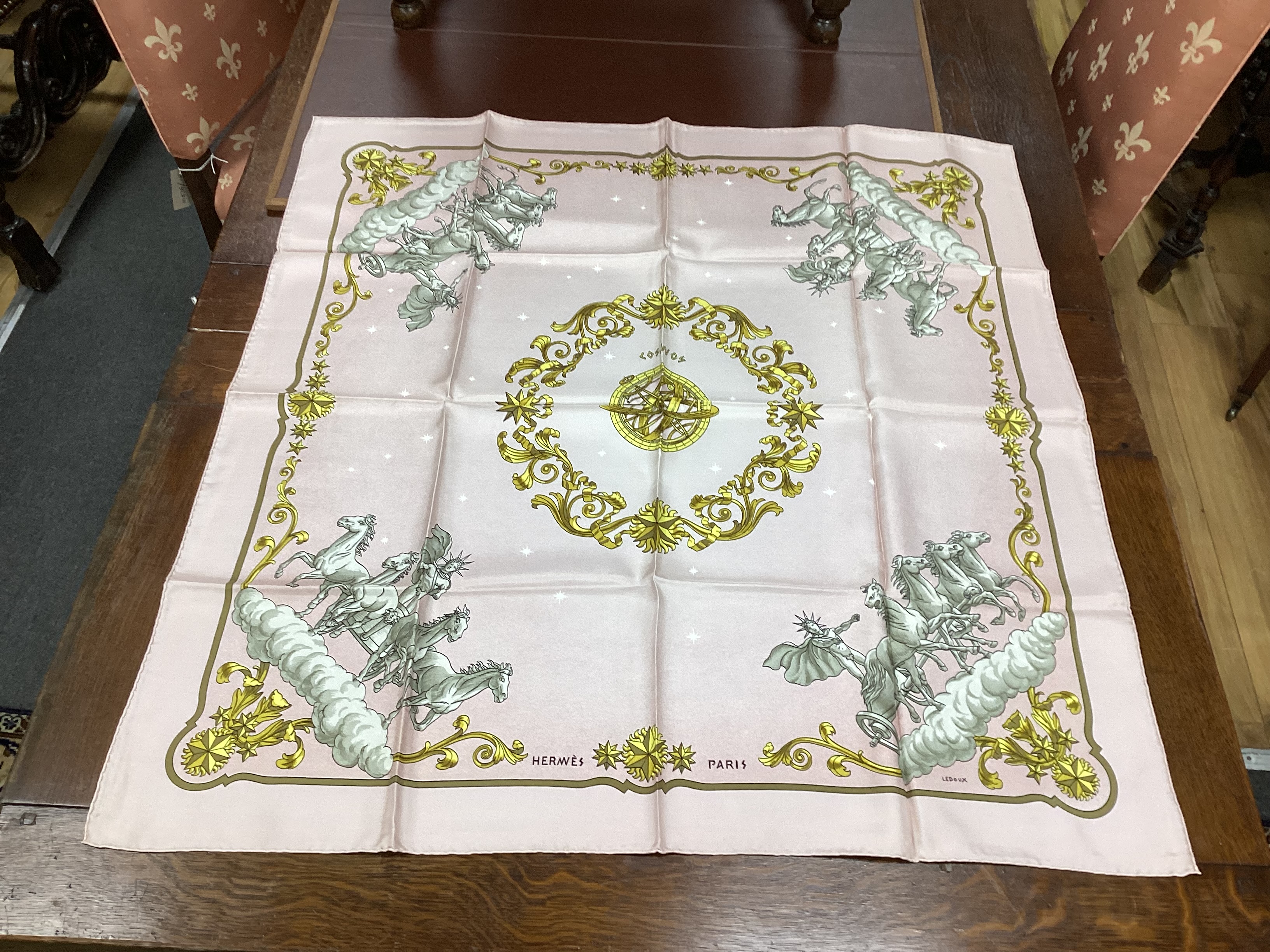 Four vintage Hermes silk scarves comprising Cosmos, Bride de Cour, Roues de Canon and a Cuivreries example retailed by Harrods